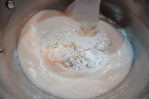 將混合物倒入麵粉中，攪拌成團，揉至三光